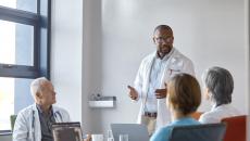 Person in white jacket giving presentation to others